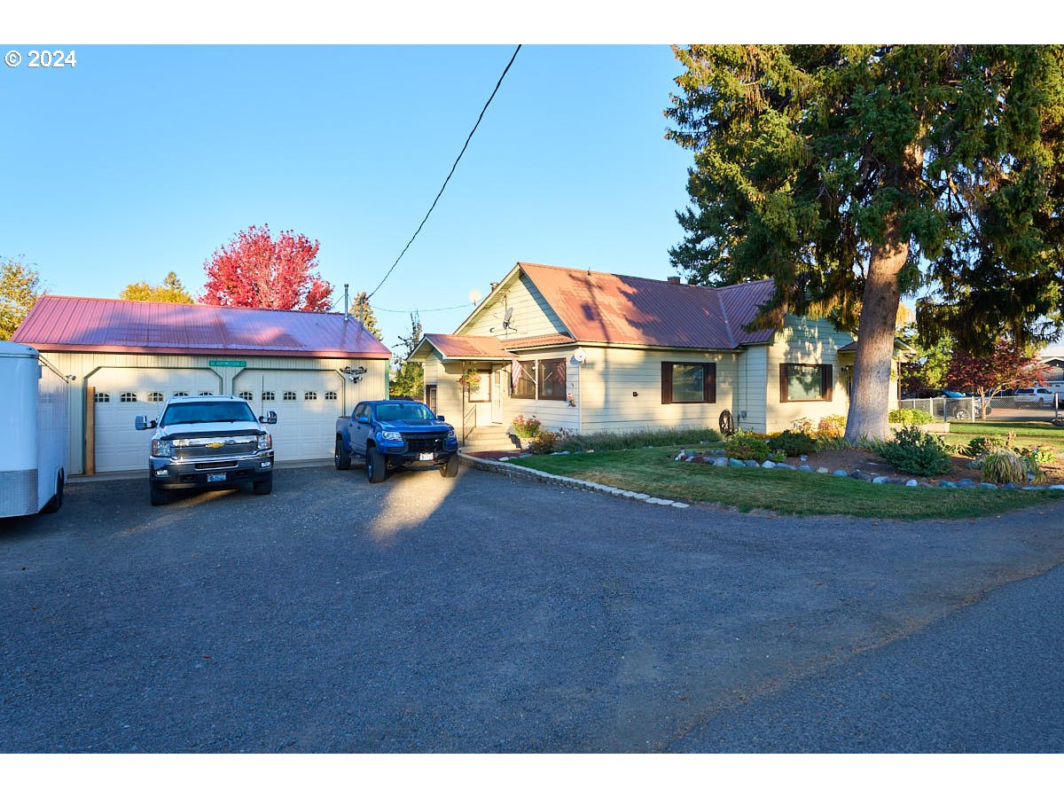 a view of house with outdoor space and car parked