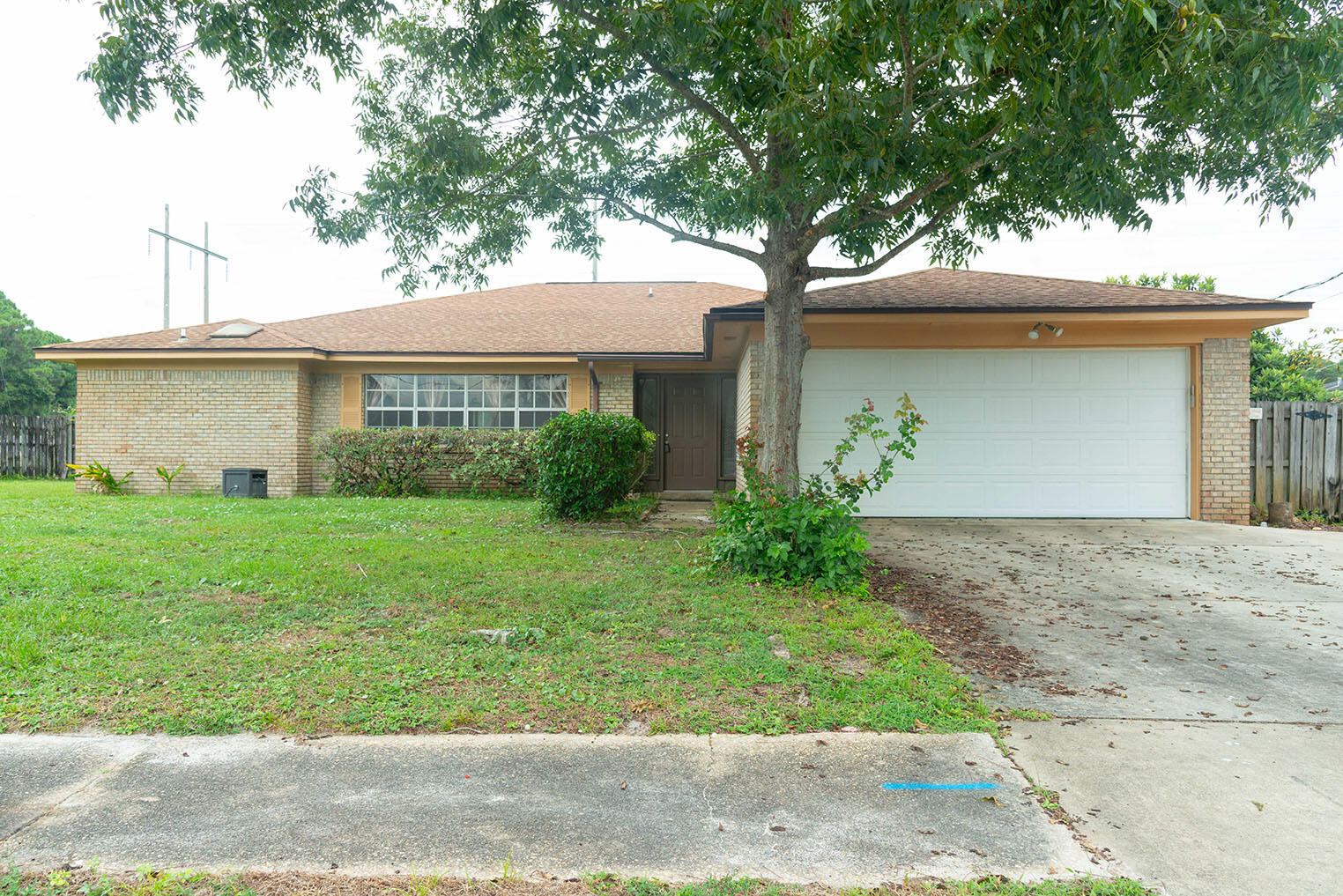 a front view of a house with a garden