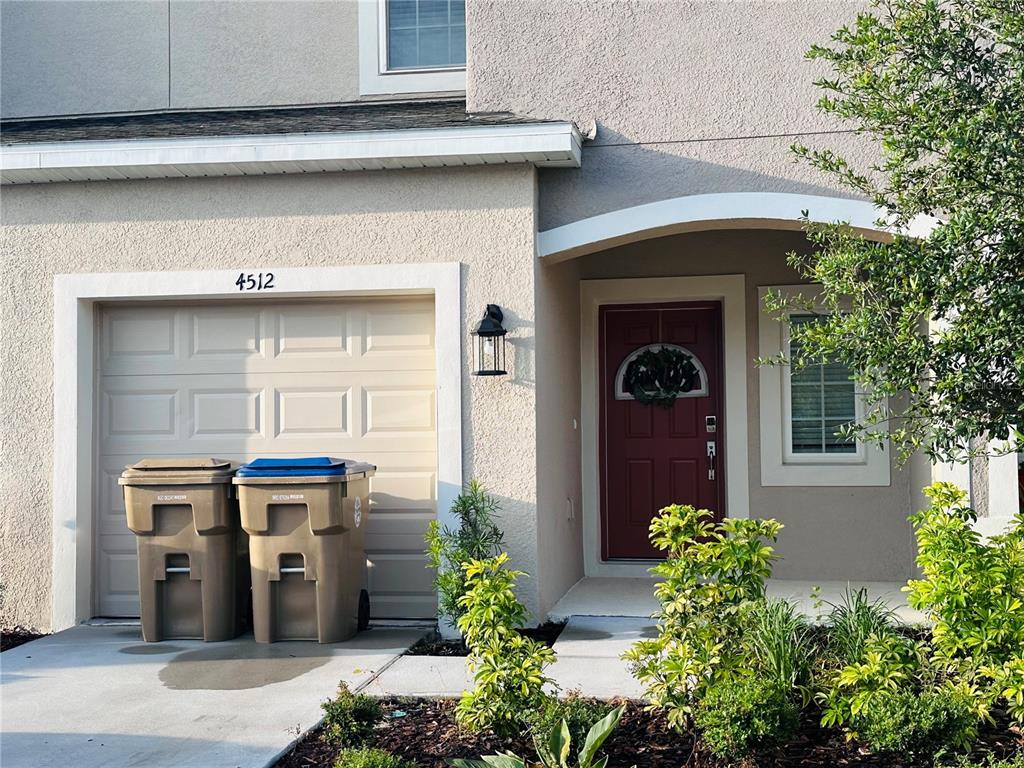 a front view of a house with potted plants