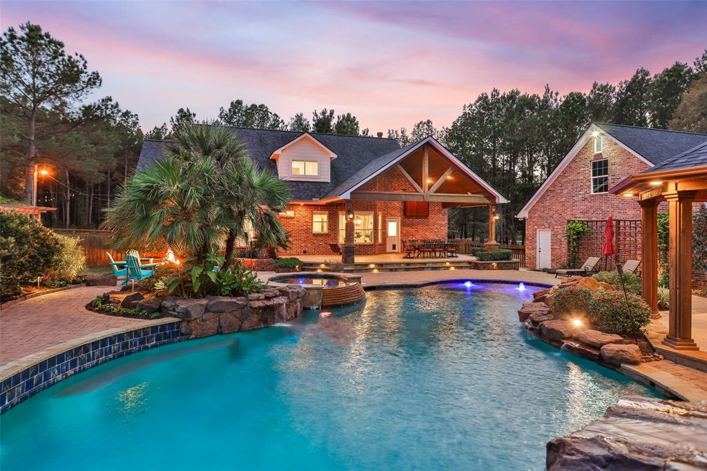 a front view of a house with swimming pool having outdoor seating