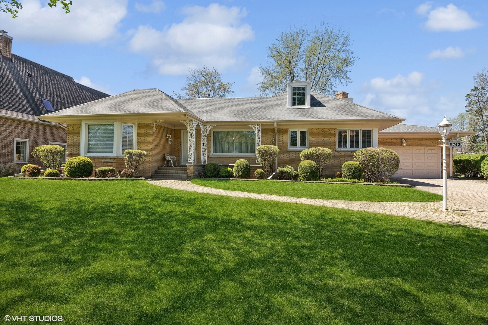 a front view of a house with garden