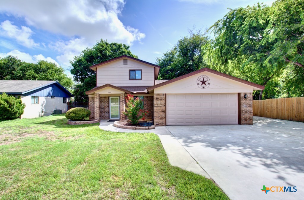 a front view of a house with a yard and garage