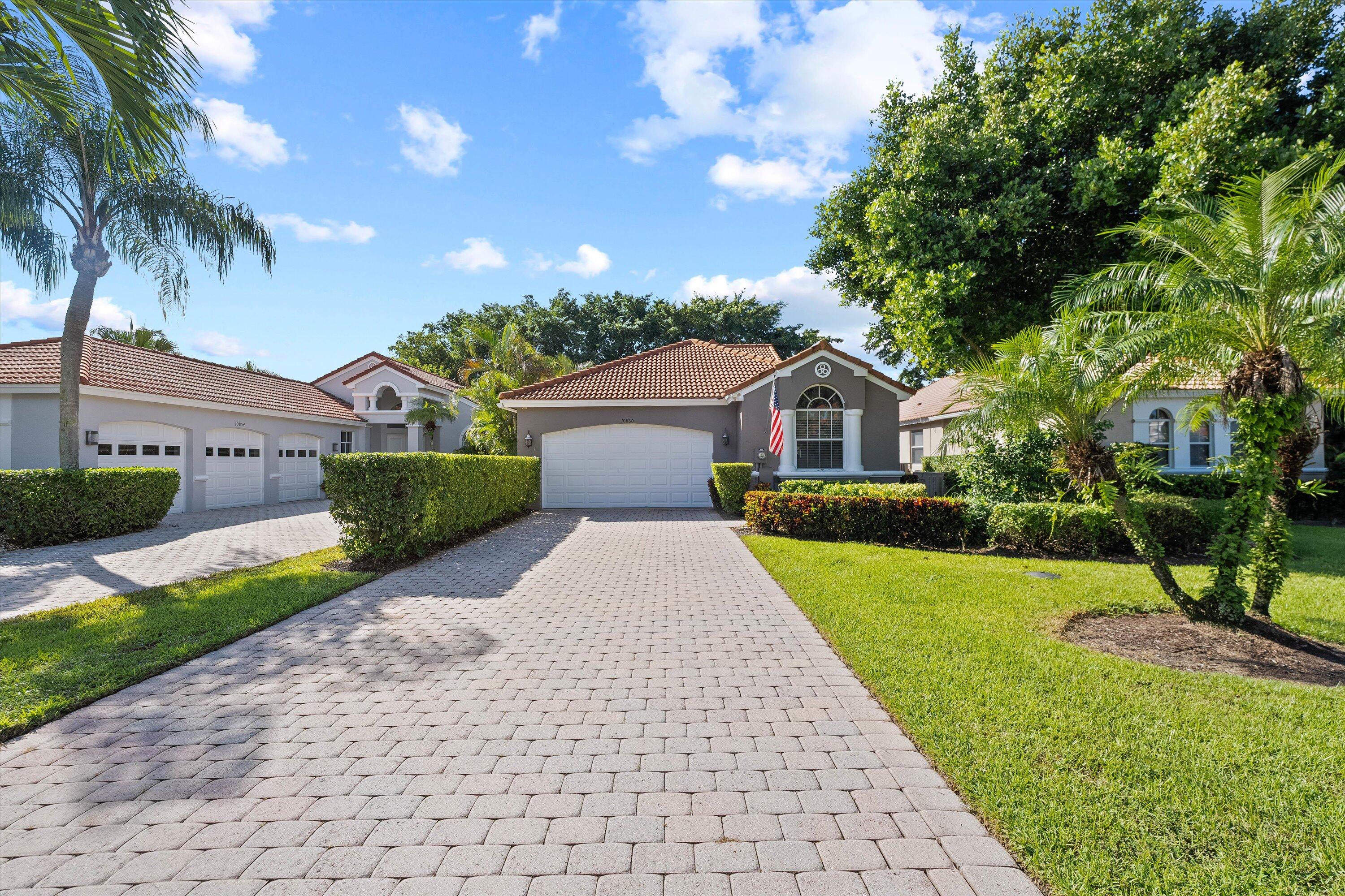 a front view of a house with a garden and yard