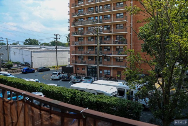 a view of a building with garden and sitting area