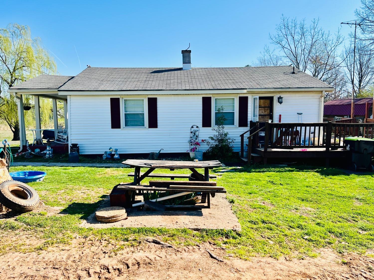 a view of a house with swimming pool and a yard