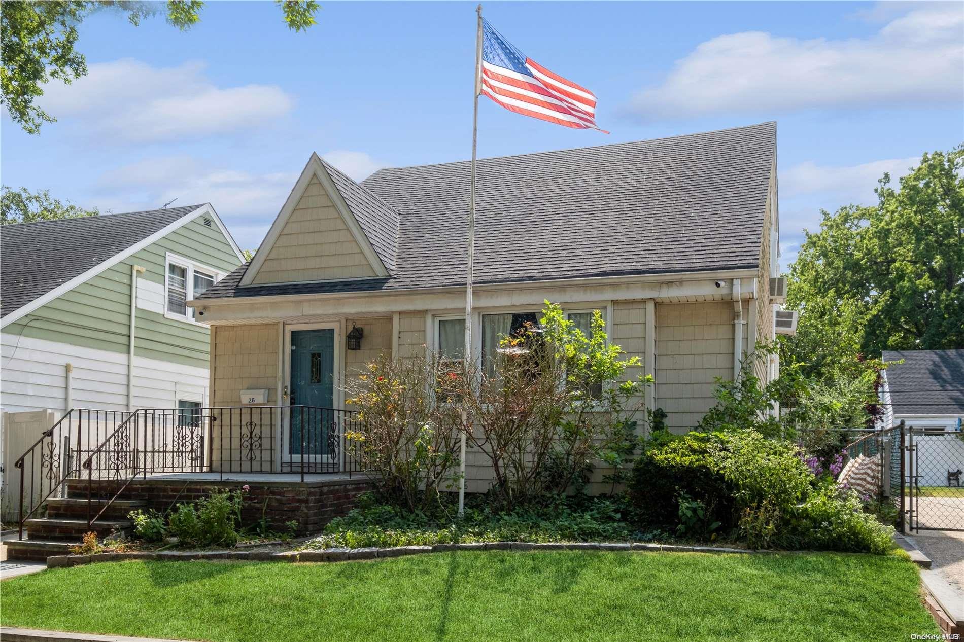 a front view of a house with a garden