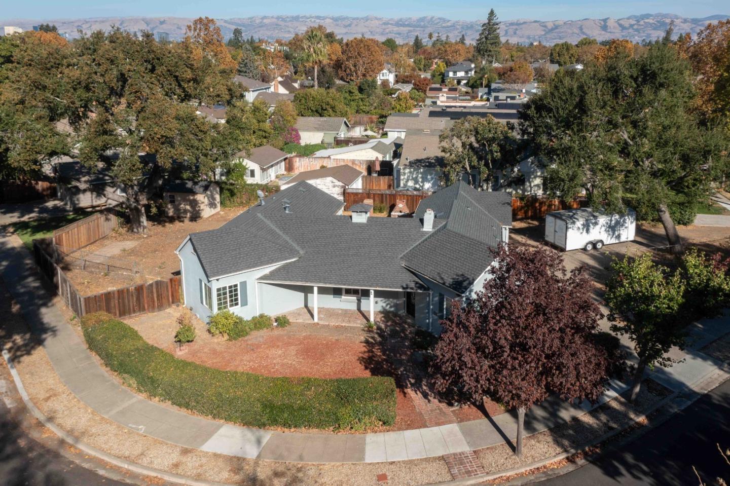 an aerial view of residential houses with outdoor space and trees