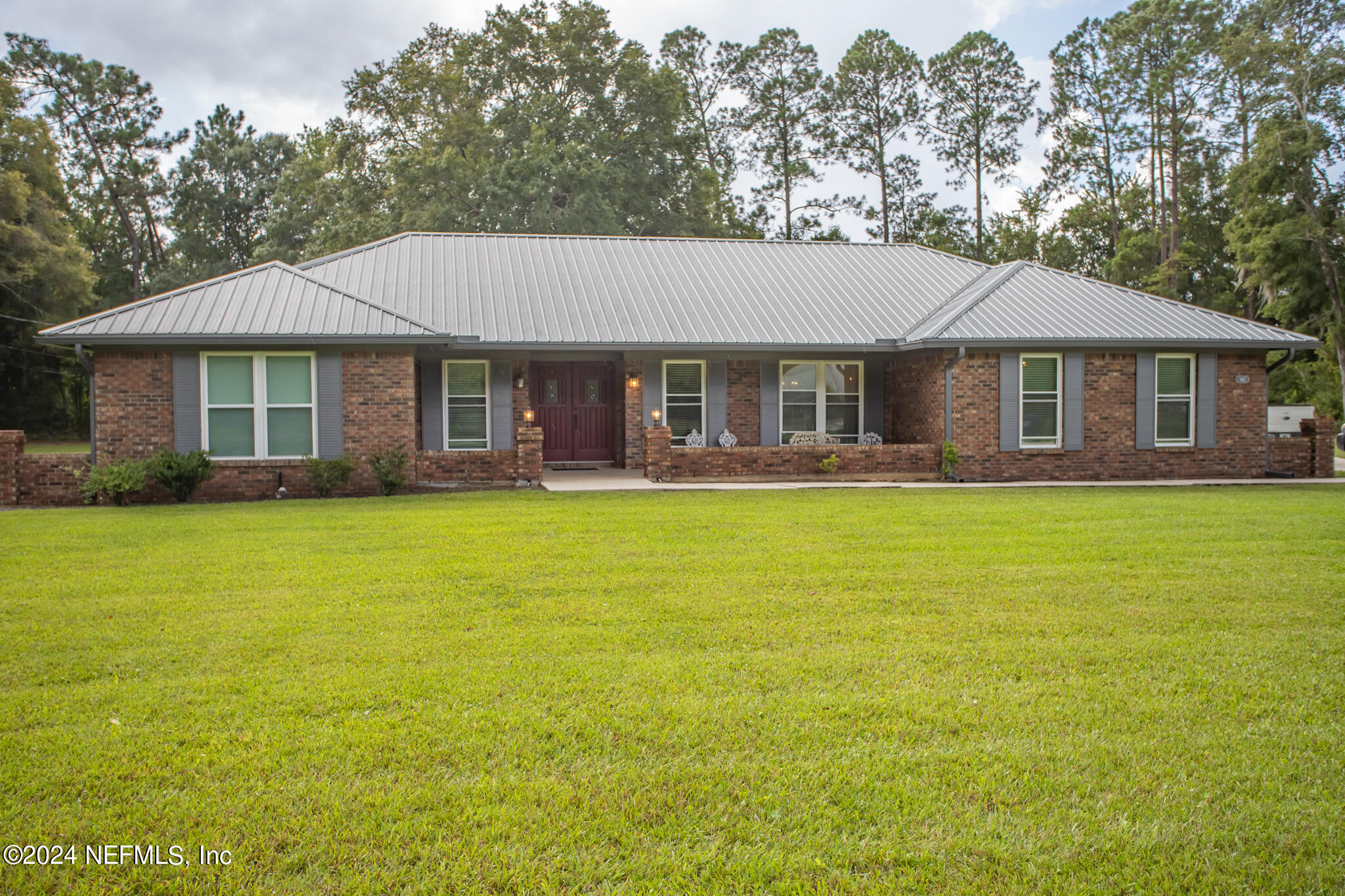 a front view of house with yard and glass windows