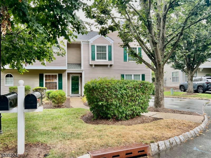 a front view of a house with garden and porch