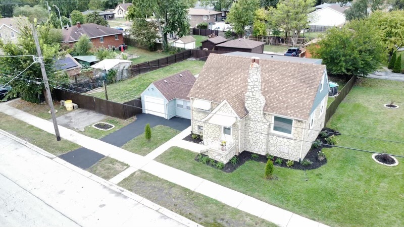 an aerial view of a house with a yard