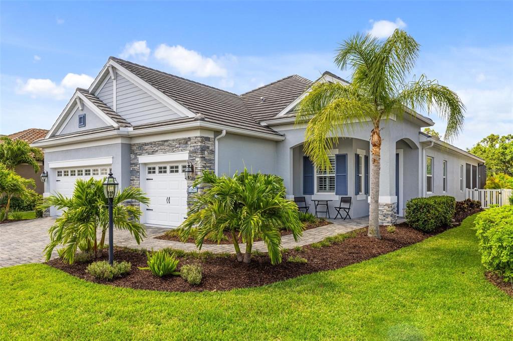 a front view of a house with a garden and plants