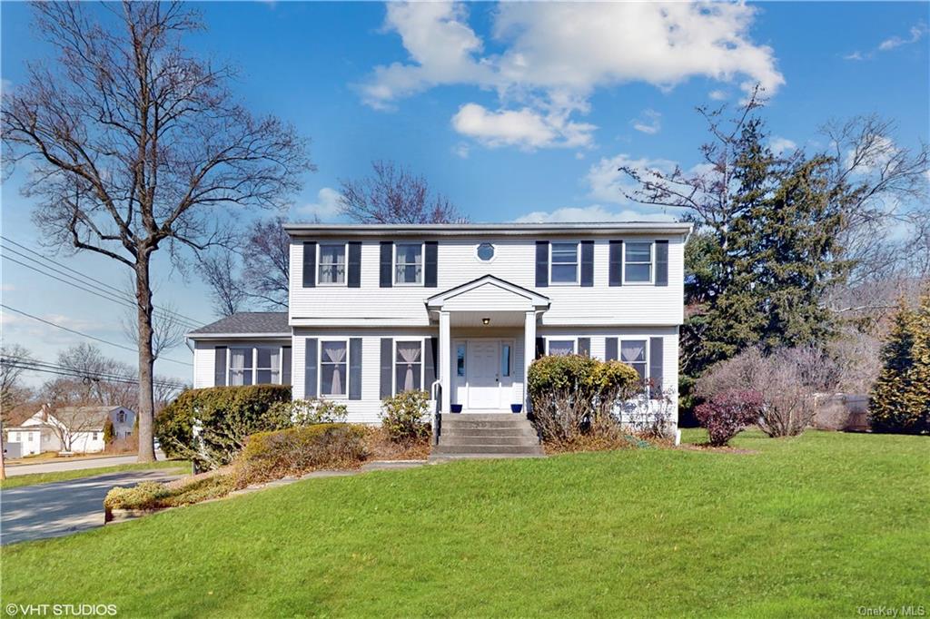 a front view of a house with a garden and a yard