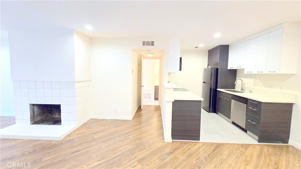 a kitchen with stainless steel appliances kitchen island wooden cabinets and granite counter tops