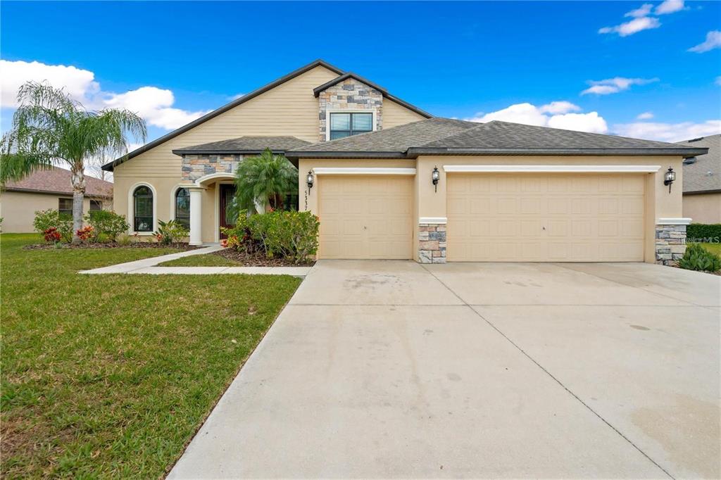 a front view of a house with a yard and garage