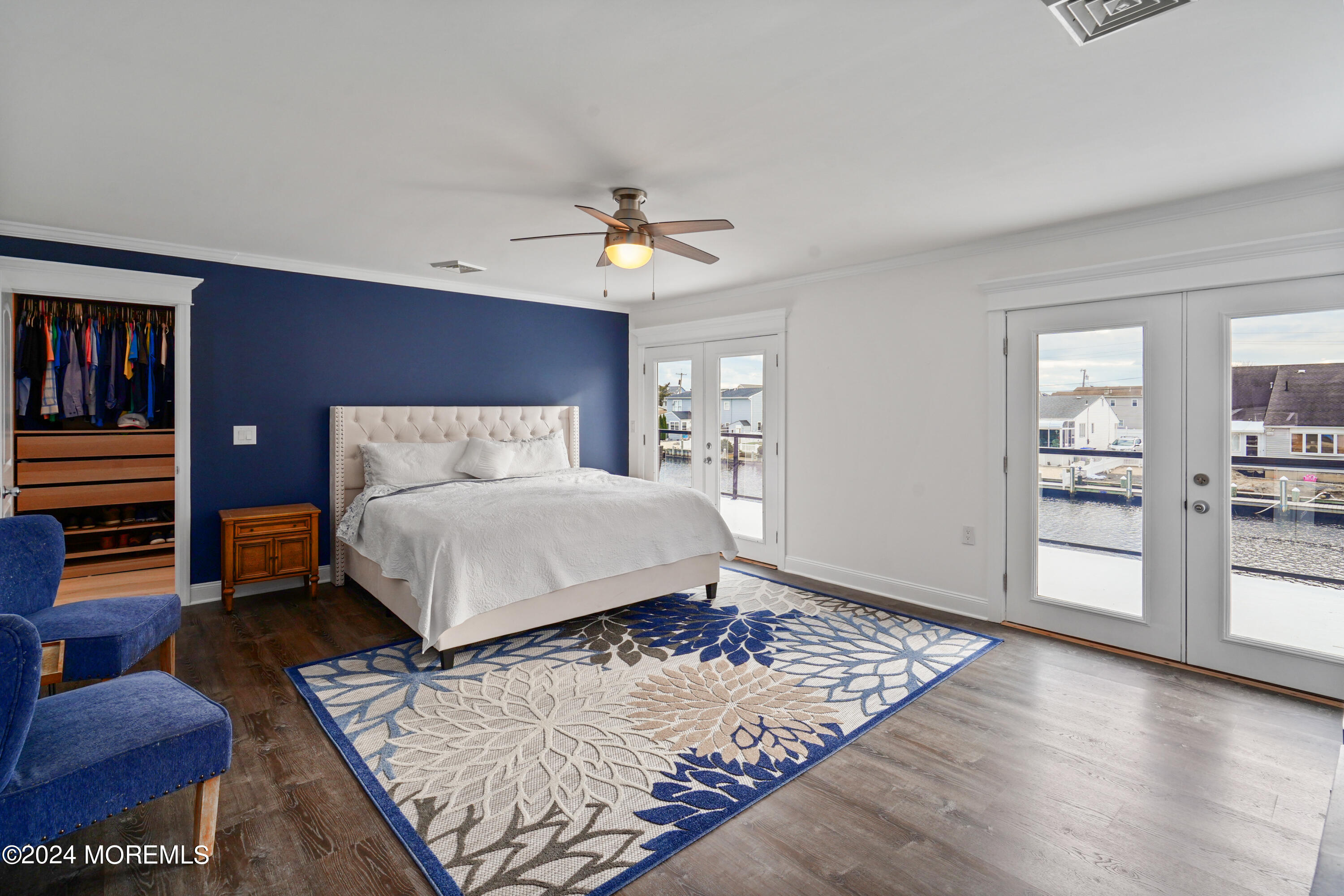 a bedroom with a bed rug and wooden floor