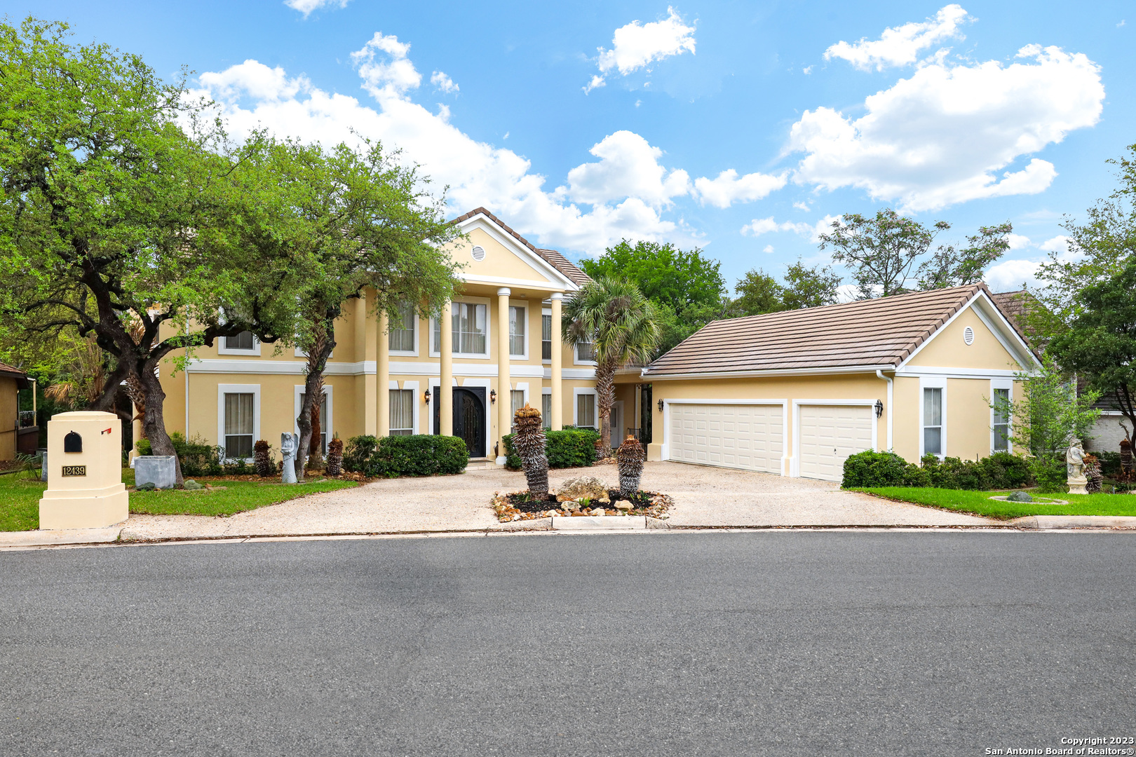 a view of house with outdoor space and parking