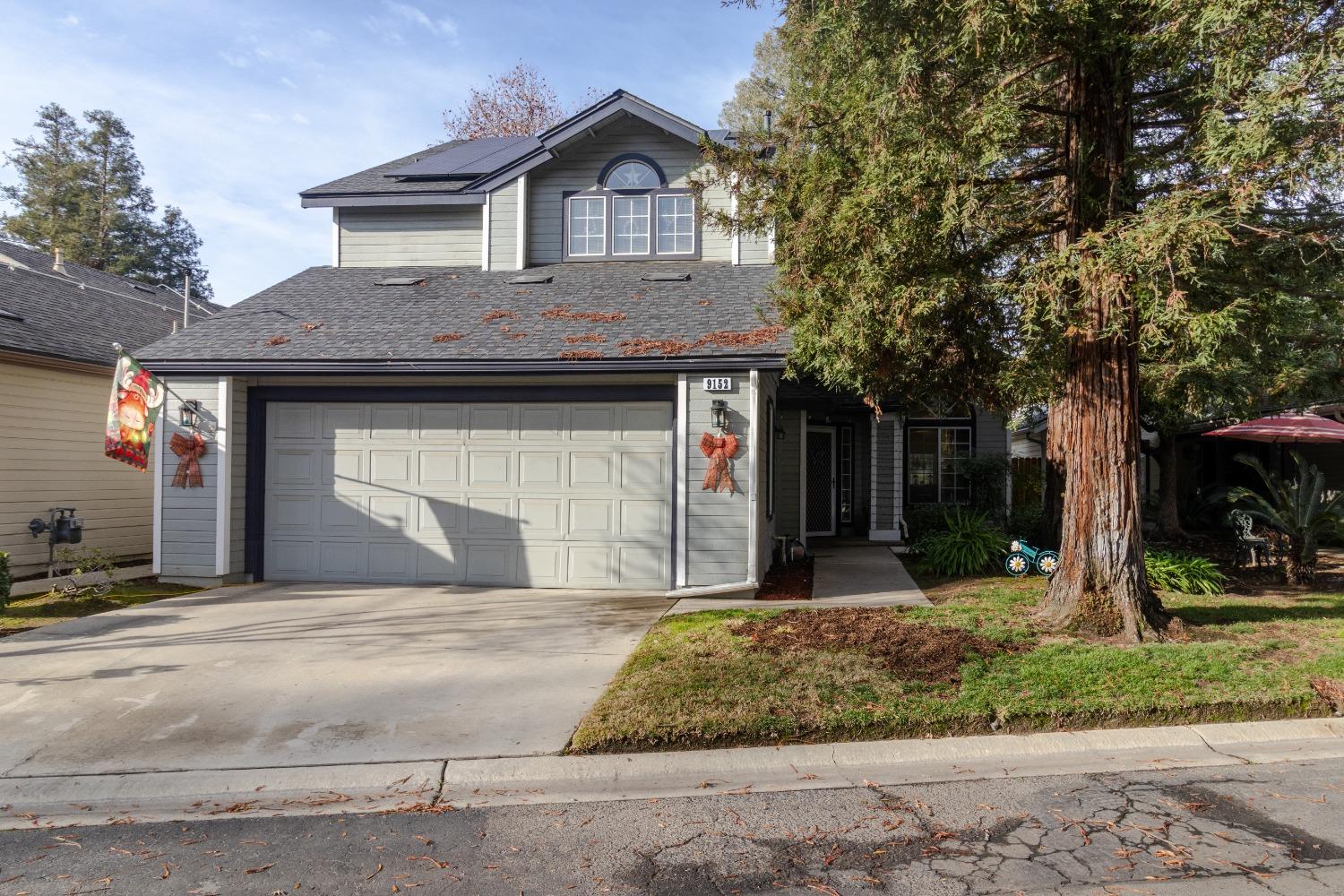 a front view of a house with a yard garage and outdoor seating