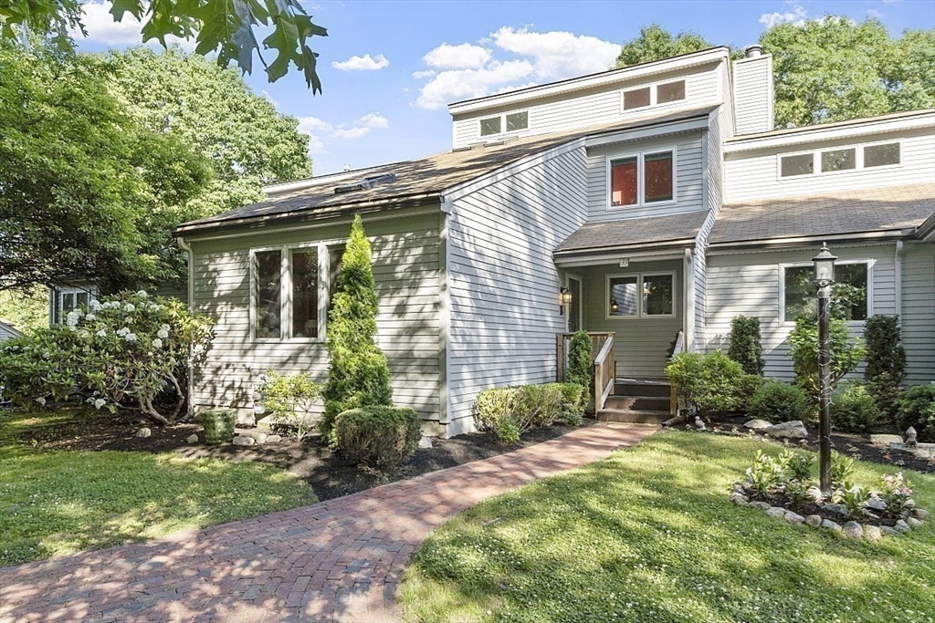 a front view of a house with a yard and porch