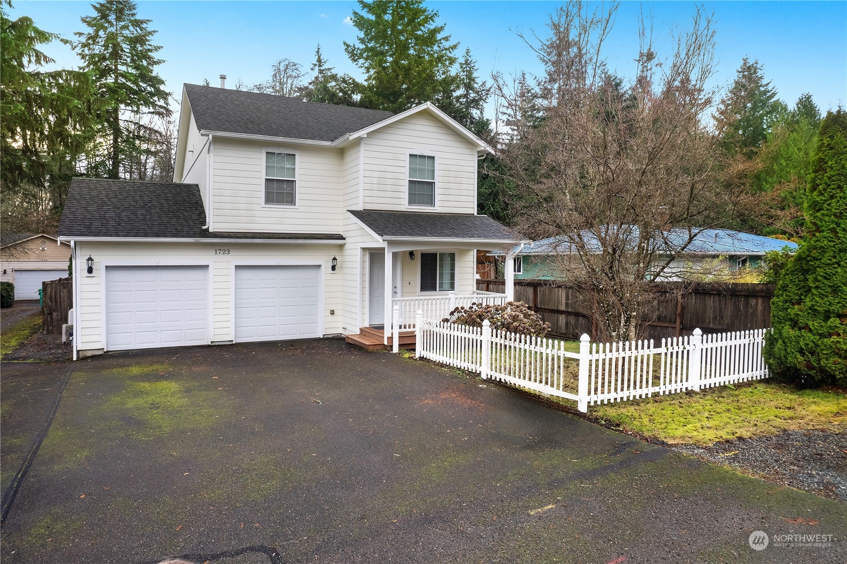 a view of a house with a yard and sitting area