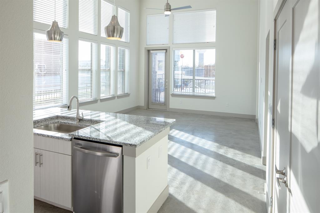 a bathroom with a granite countertop sink and a window