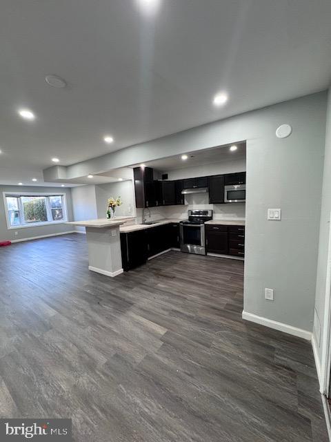 a view of kitchen and kitchen with stainless steel appliances