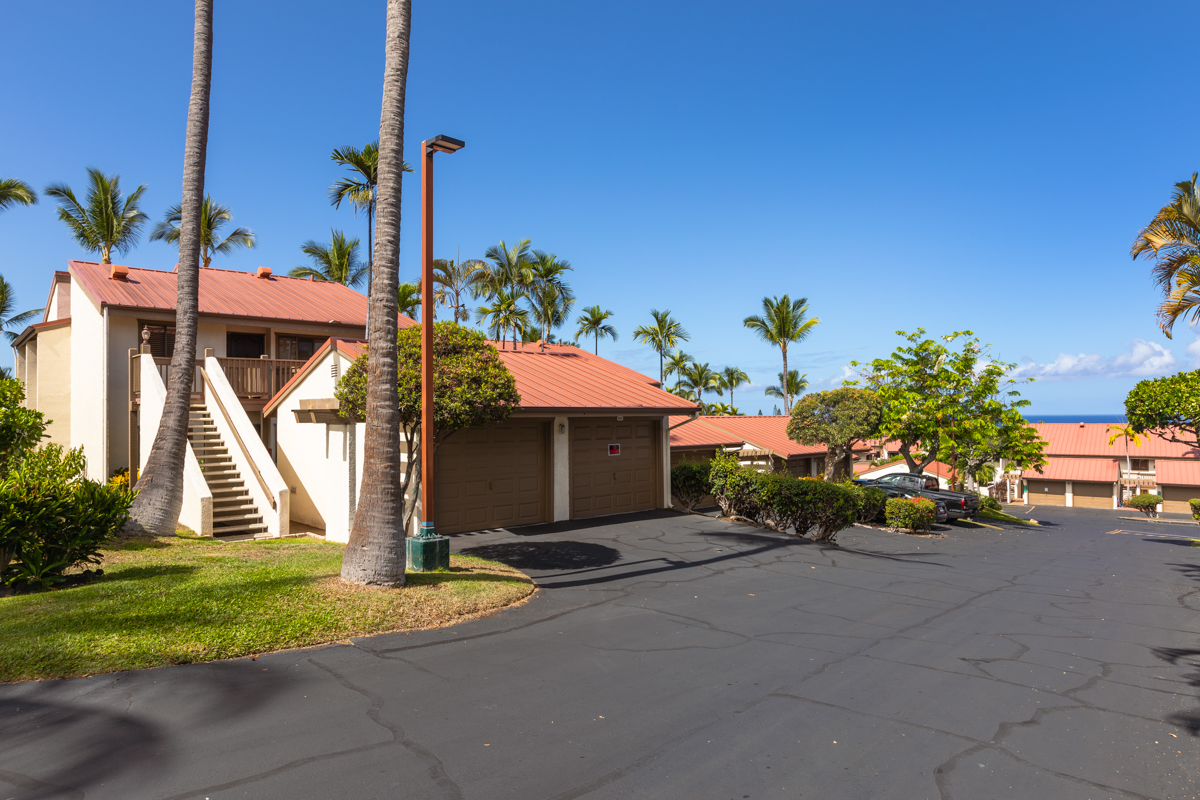 a front view of a house with a yard and a garage