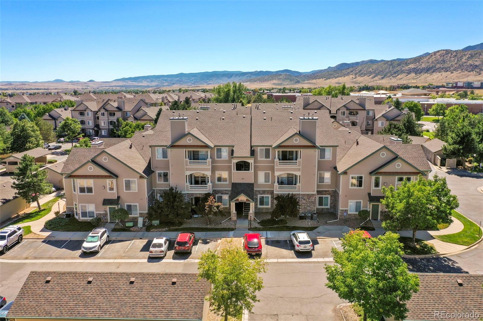 an aerial view of multiple houses with a street