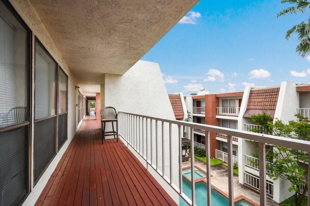 a view of a balcony with wooden floor