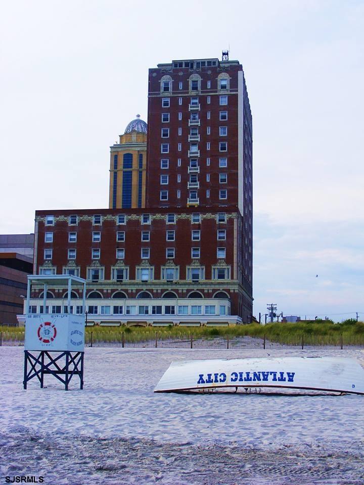 a view of a tall building with a swimming pool