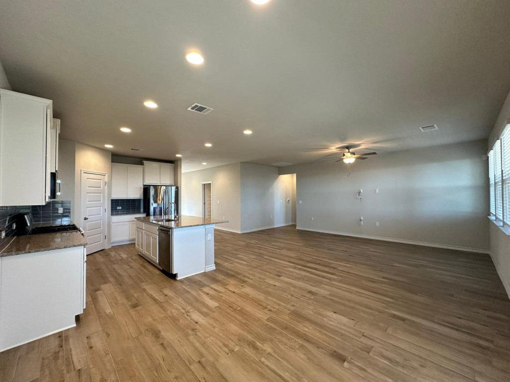 a view of kitchen with cabinets stainless steel appliances a sink and a counter top