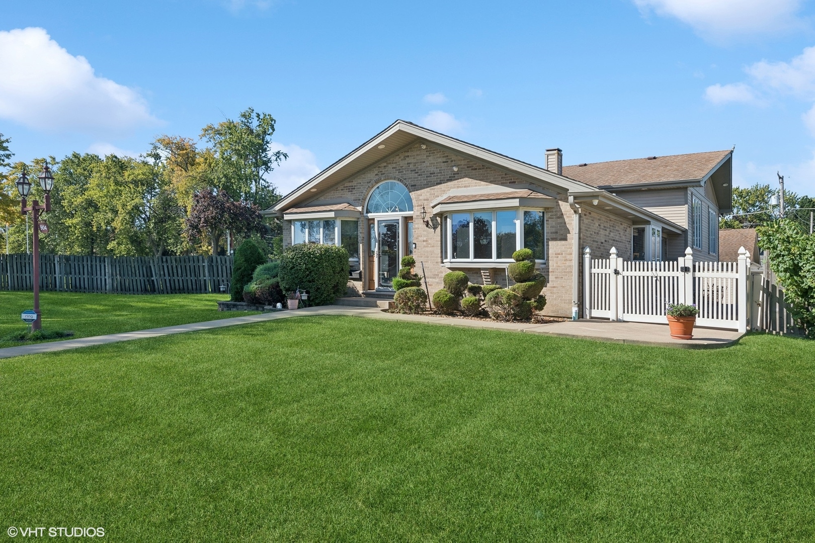 a front view of house with yard and green space