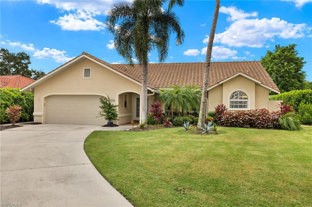 View of front of house featuring a garage and a front yard