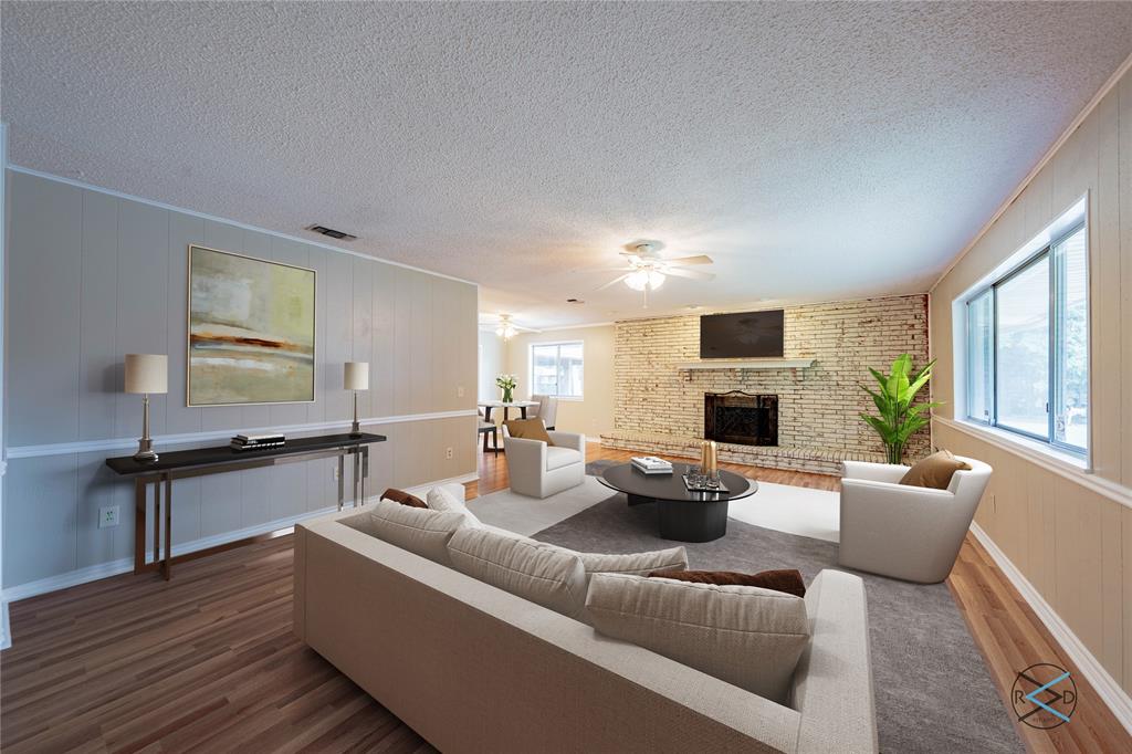 a living room with fireplace furniture and a wooden floor