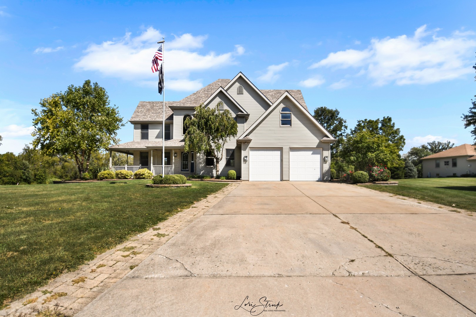 a front view of a house with a yard and trees