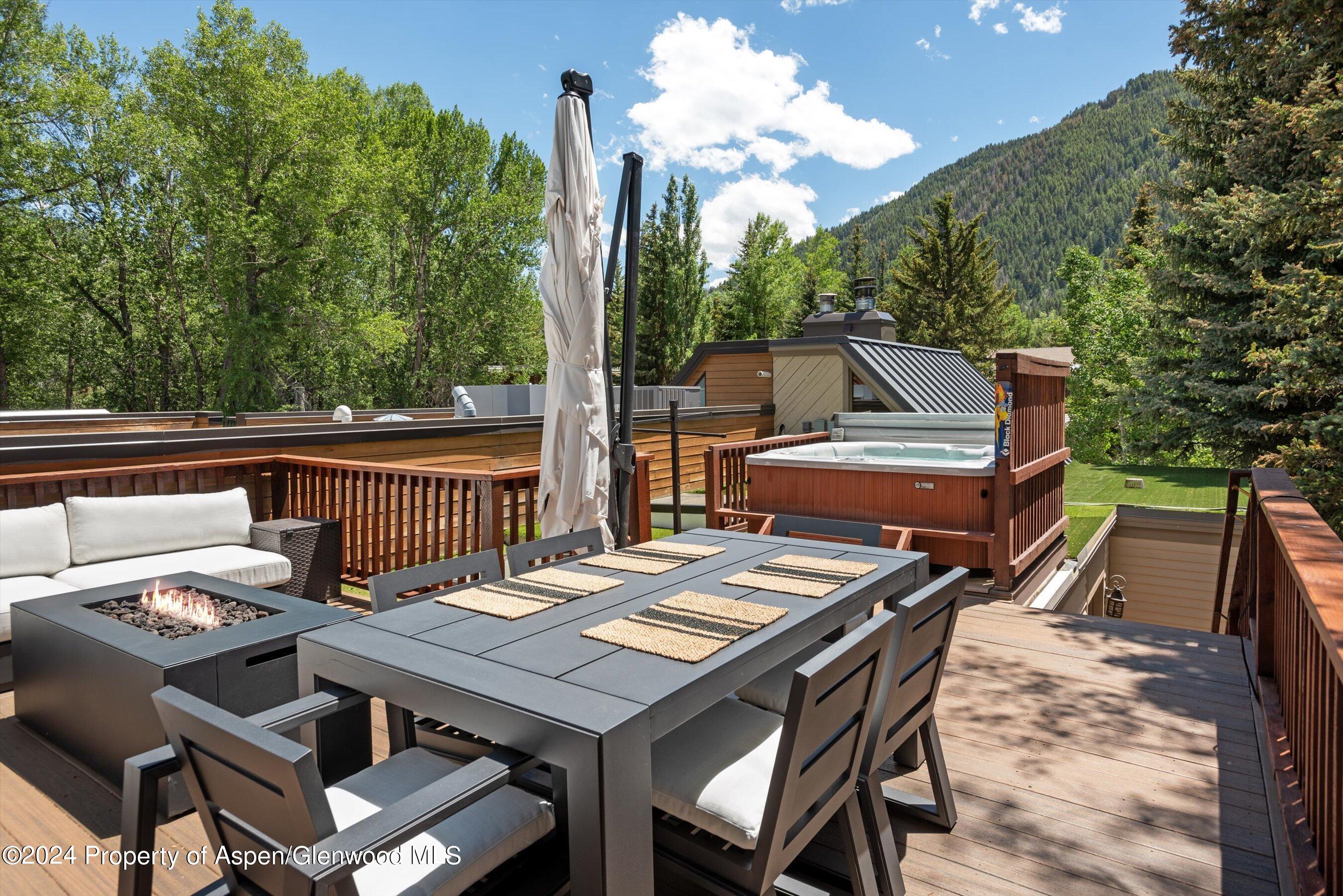 a view of a dinning table and chairs in the roof deck