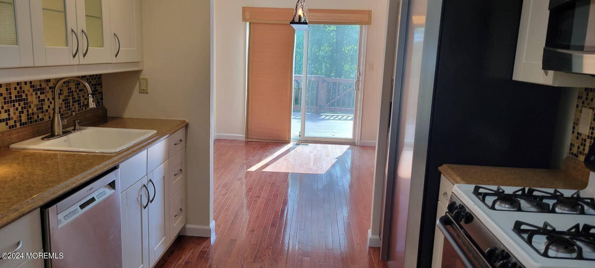 a kitchen with a sink stove and cabinets