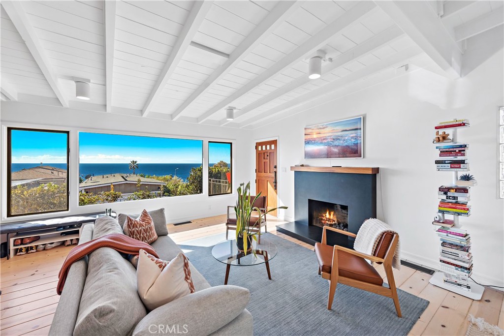 a living room with furniture fireplace and a large window