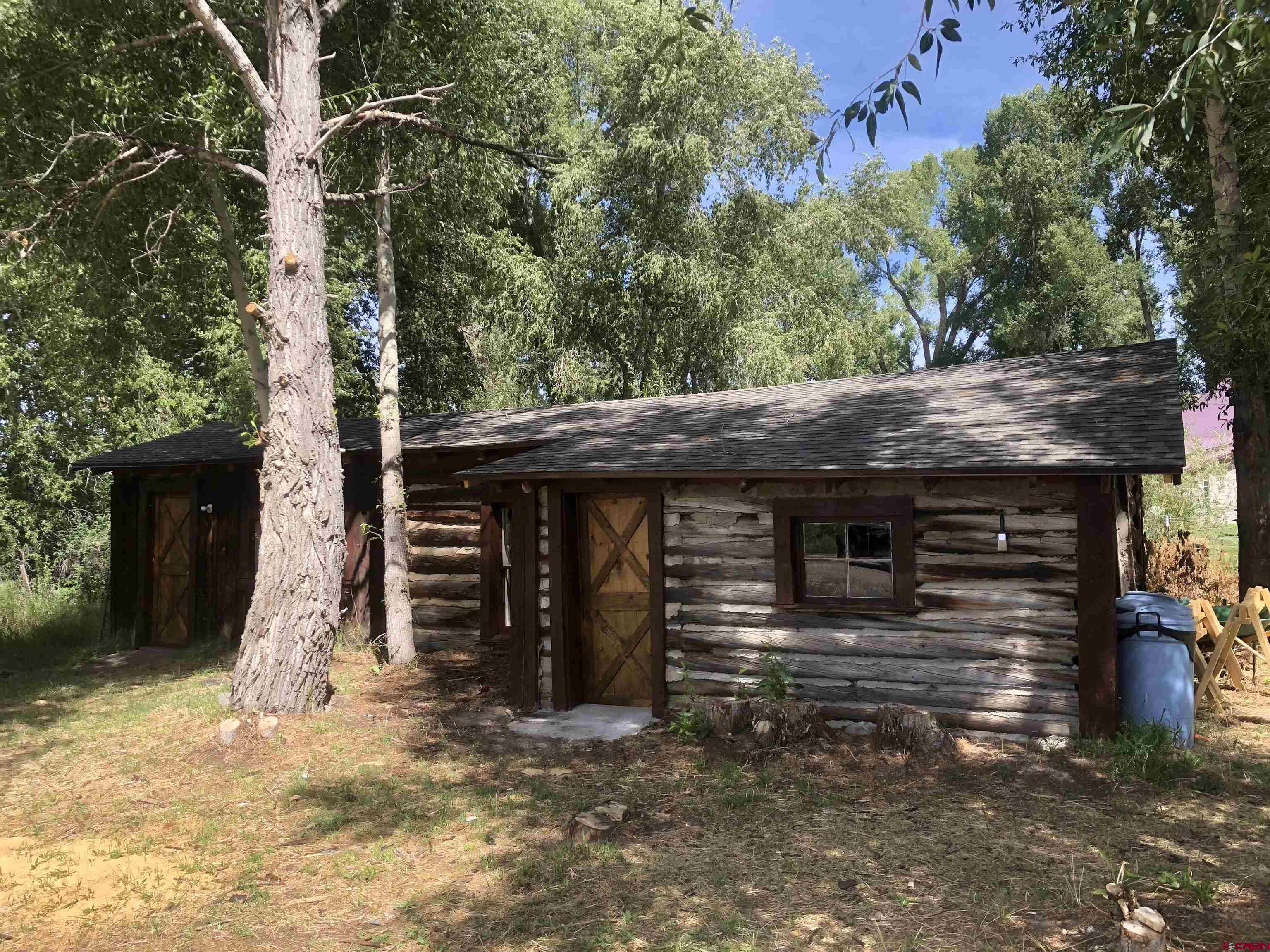 a front view of a house with a tree