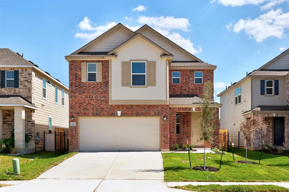 a front view of a house with a yard and garage