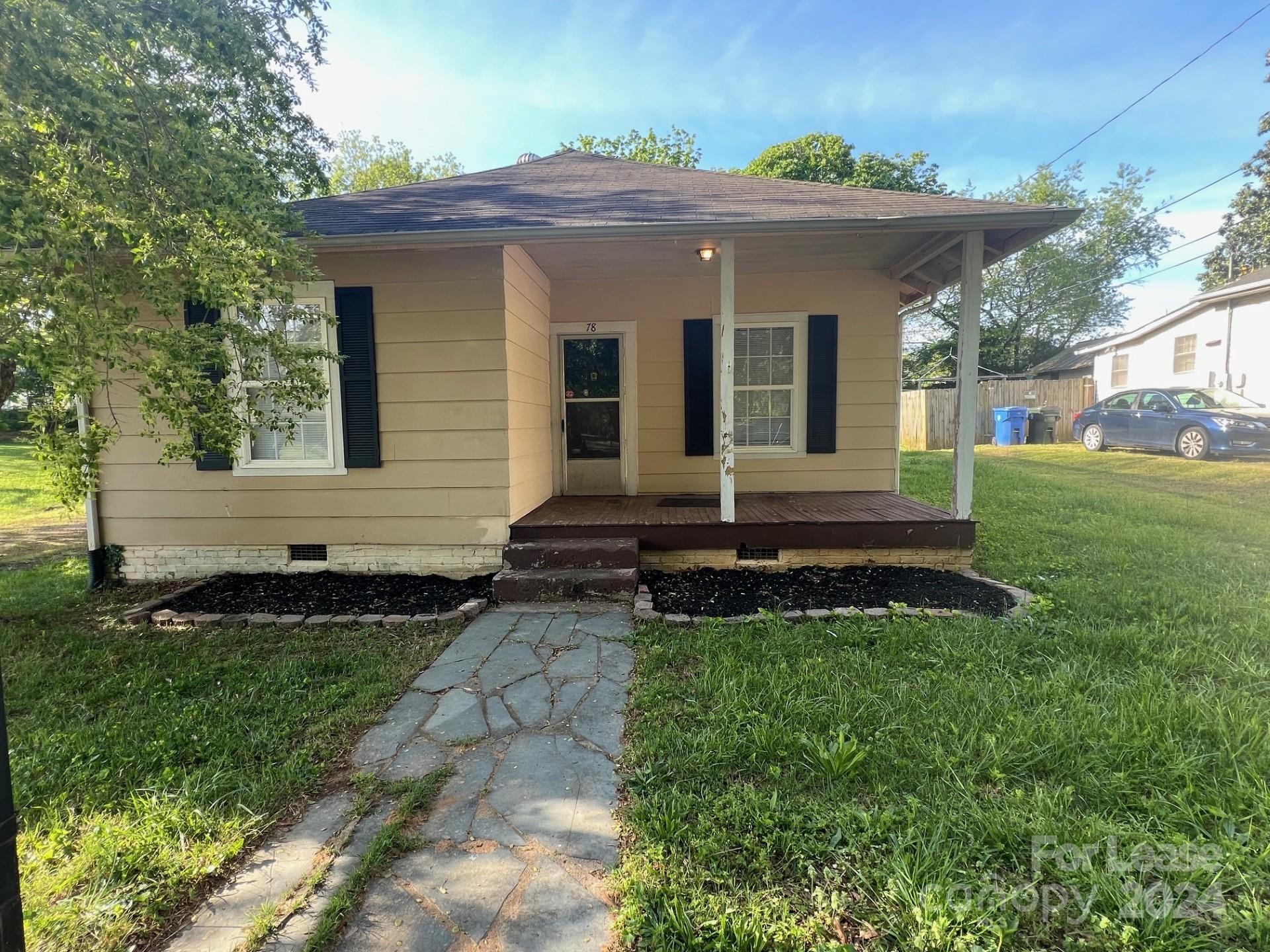 a view of house with backyard