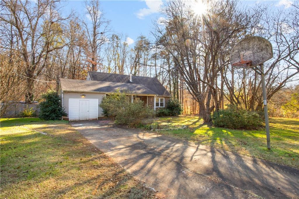 a view of a house with a yard and tree s