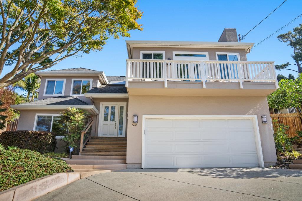 a front view of a house with a garage