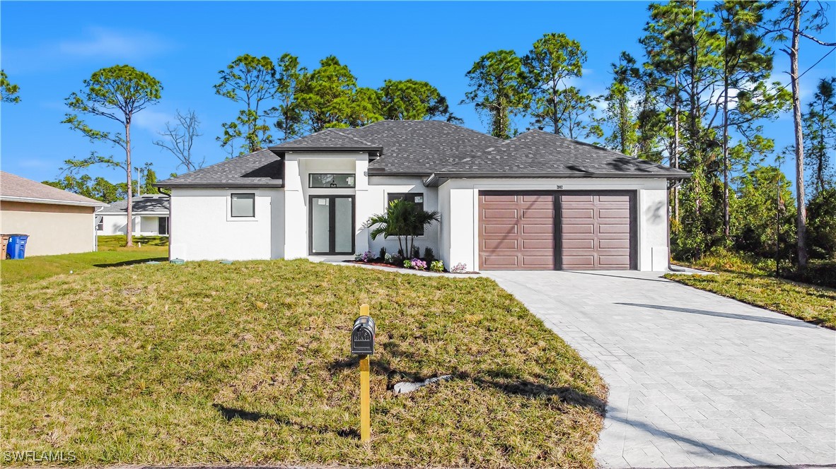 a front view of a house with a yard and garage