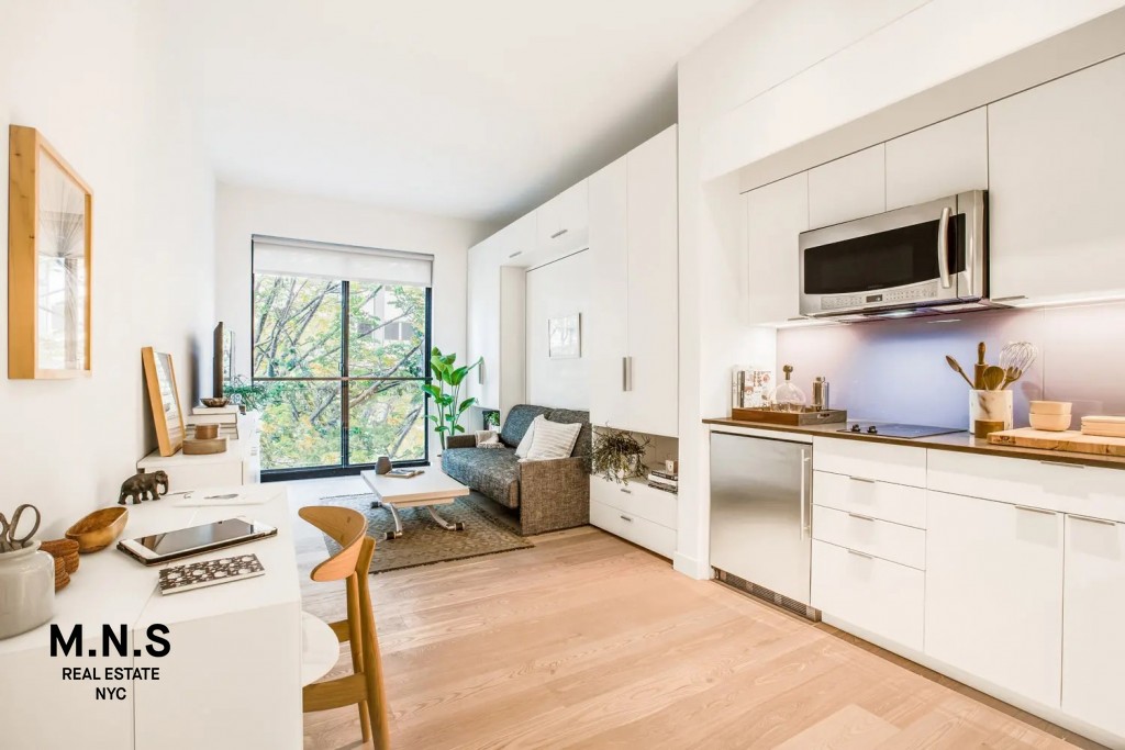 a living room with furniture a flat screen tv and a window