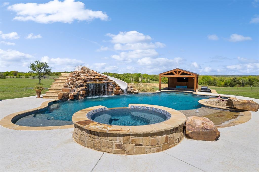 a view of swimming pool with seating space