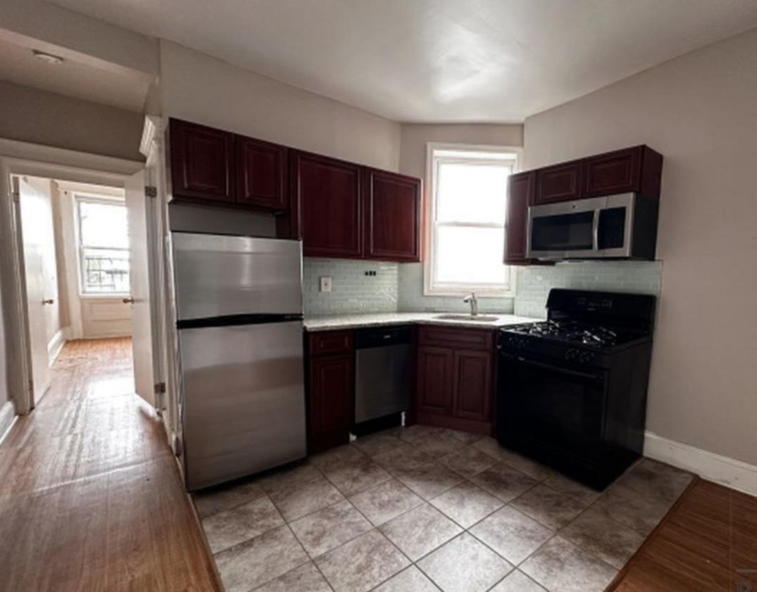 a kitchen with a refrigerator stove and microwave