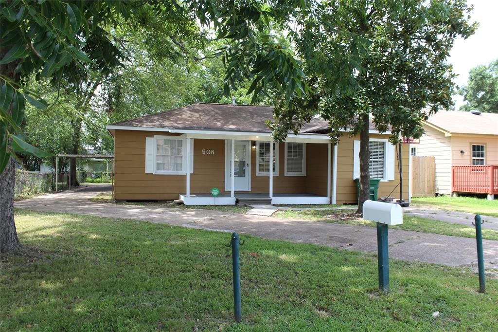 a view of a house with a yard and tree s