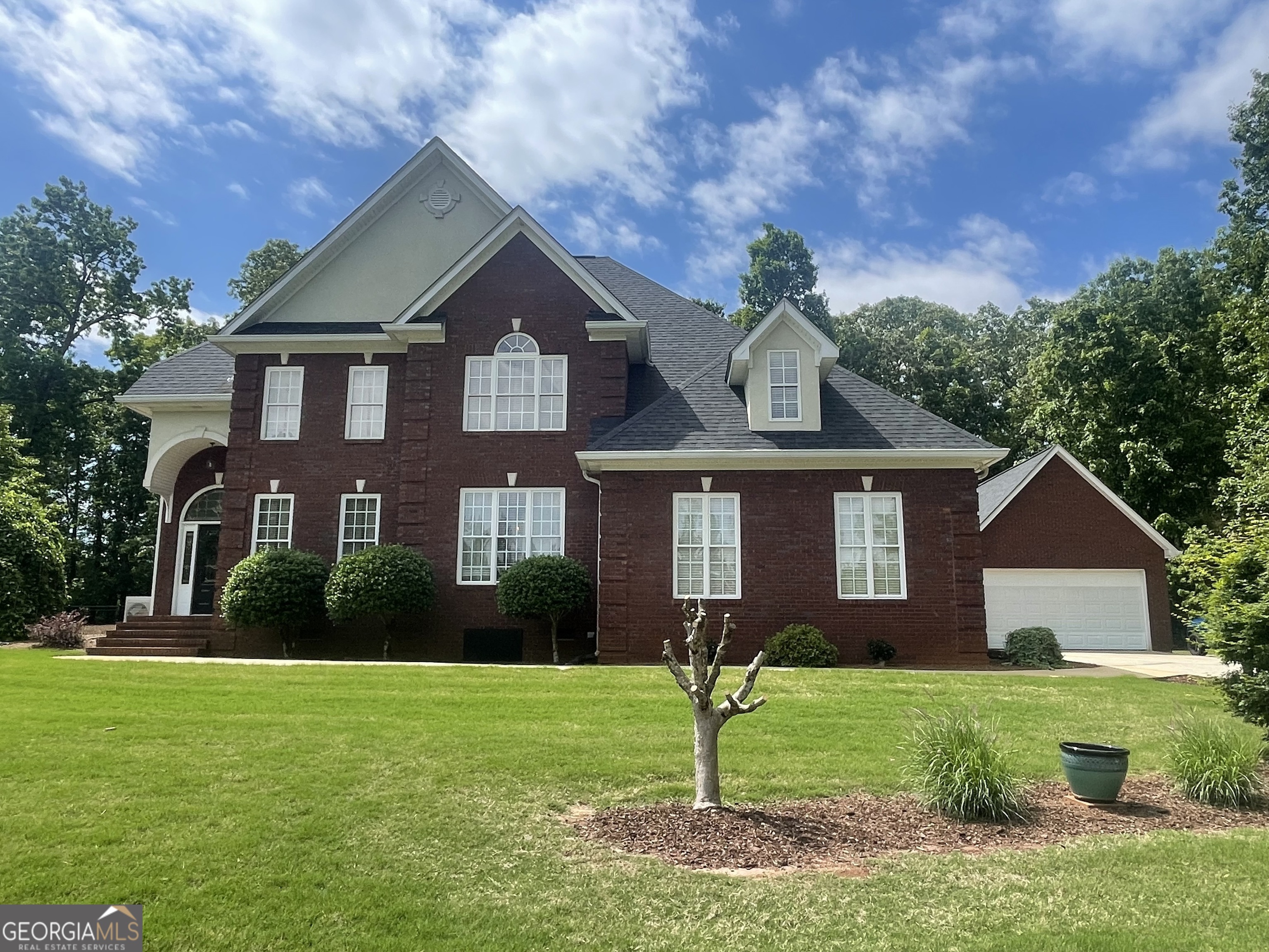 a front view of a house with a yard