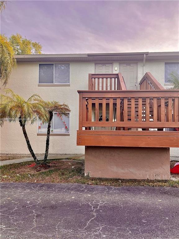 a view of a house with backyard and deck