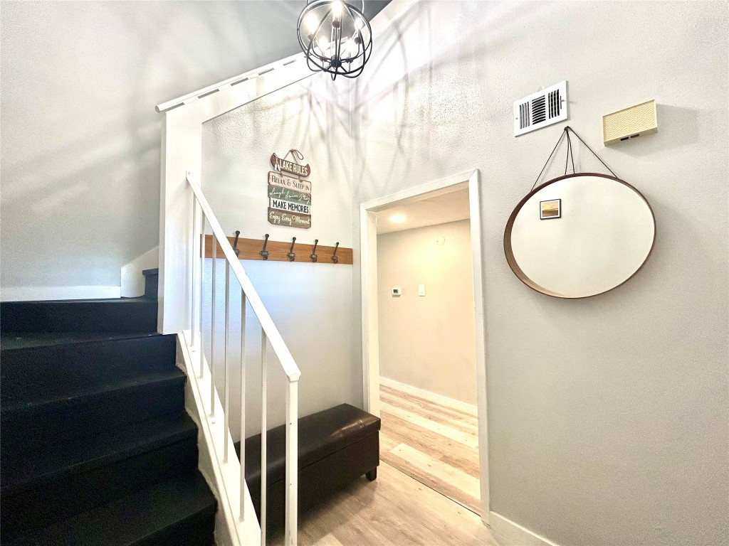 a view of a livingroom with wooden floor and entryway